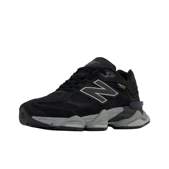 New Balance NB 9060 sneakers, black upper with thick gray sole, unisex lifestyle shoes.