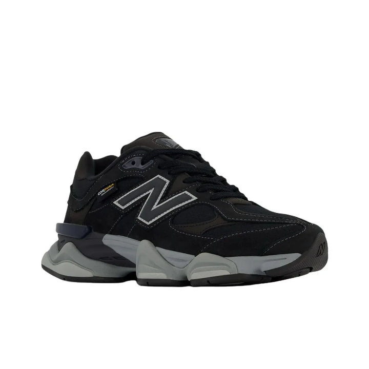 New Balance NB 9060 unisex black lifestyle sneakers with thick gray sole.